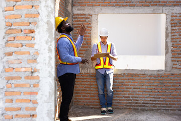 interior design : Architects and contractor working together inside building under construction...