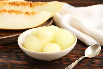 Cut ripe melon on wooden table, closeup