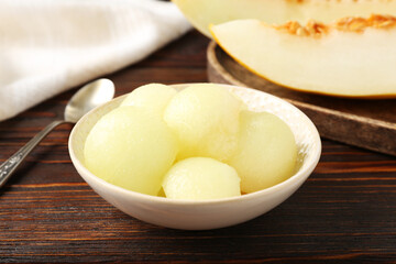 Cut ripe melon on wooden table, closeup