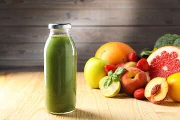 Tasty juice in glass bottle, fresh ingredients and basil on wooden table against brown background,...