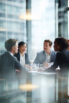 Business men and women wearing suit or formal outfit, discussing at their meeting with co-worker and client at   modern office in urban building. 