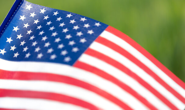 Close-up of waving American flag with stars and stripes on green background - Powered by Adobe