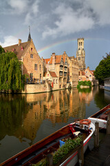 Historic Bruges Rozenhoedkaai Canal Rainbow. A rainbow over the historic city of Bruges, Belgium, with medieval buildings, canals and belfry.

