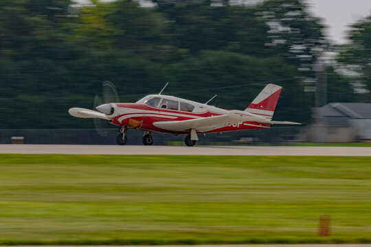 Piper Comanche Red and White Classic Aircraft Taking Off