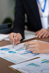 Financial advisor analyzing data with client in office setting