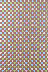 green, blue, pink, and cream dots on brown