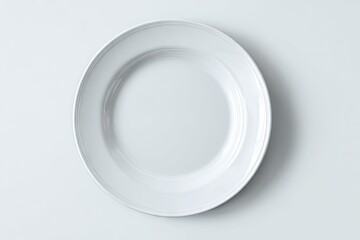 A simple, shallow, oval white plate sits on a plain white background, viewed from directly above.  The plate shows subtle concentric rings