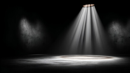 Spotlight beams onto a dark grungetextured stage or room creating a stark contrast of light and shadow