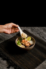 Tekwan, Palembang fish ball soup with shrimp, vermicelli, mushrooms and lime. Hand serving a dumpling above a warm bowl—great for menus, blogs, recipe cards, and Asian cuisine promotions.
