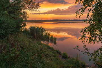 sunrise over the lake with reflections clouds in the water
