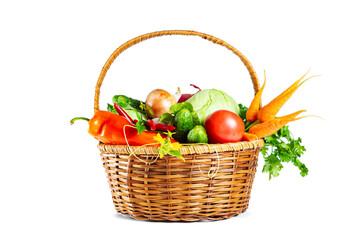 Fresh shiny different vegetables in a wicker basket. Isolated on white background.