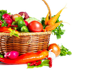Fresh shiny different vegetables in a wicker basket. Isolated on white background.