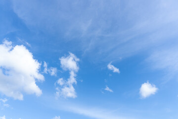 Low angle view and full frame of beautiful blue sky with strange shape of fluffy white clouds in the afternoon on sunny day used as natural background texture in decorative art work