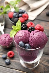 Delicious sorbet with fresh berries and mint on wooden table, closeup