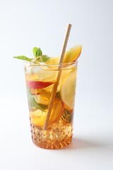 Tasty iced tea with lemon, peach and mint on white background