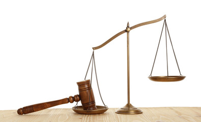 Golden scales of justice and gavel on wooden table against white background