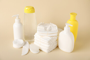 Baby accessories and cosmetic products on beige background