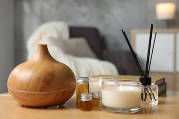 Spa composition with burning candles on wooden table indoors, closeup