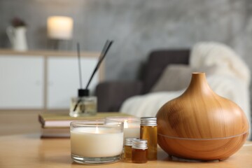 Spa composition with burning candles on wooden table indoors, closeup