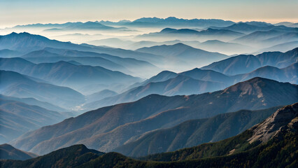 Layered blue mountain ranges fading into atmospheric haze under a clear sky full hd 4k stock image download