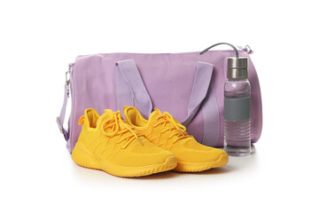 Stylish sports bag, bottle and sneakers isolated on white