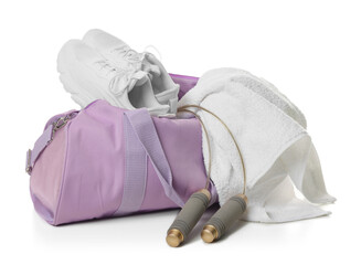 Stylish sports bag with sneakers, towel and skipping rope isolated on white