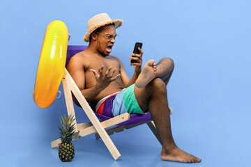 Frustrated black guy shouting at smartphone, feeling stressed, having bad internet connection on...