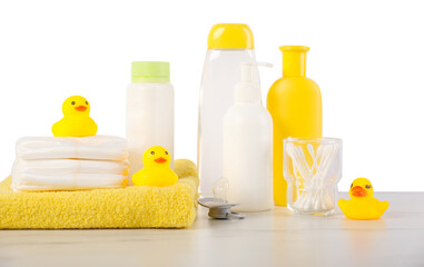 Many different baby bathroom necessities on table against white background