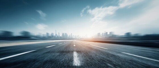The empty road leading towards a vibrant city skyline at sunset.