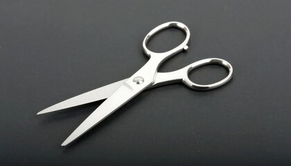 Shiny Scissors on a Dark Surface: A pair of shiny scissors, with blades open, lie on a dark backdrop. The photograph emphasizes the precision and sharpness of the tool.