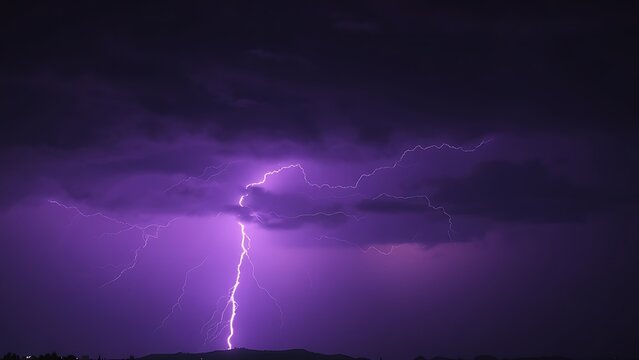 Dramatic purple lightning illuminating a stormy night sky, capturing raw natural energy.
