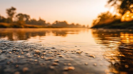 Serene riverbank at sunrise with reflections and tranquil waters
