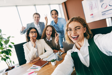 Group of colleagues sharing a cheerful moment in a modern office environment