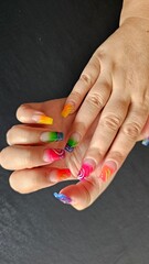 Close-Up of Vibrant Rainbow Gradient Nail Art with Creative Patterns