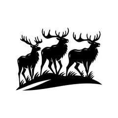 Silhouette of three majestic deer with large antlers standing on a hill