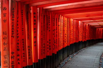 Fotobehang Torii Gates At sunrise, the red torii gates of Fushimi Inari Shrine in Kyoto glow in golden morning light, creating a serene and spiritual scene that reflects the sacred beauty of this iconic site.  © Riccardo Saponi