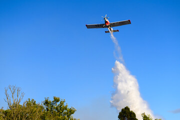 Water Bomber Aircraft in Action Against a Clear Blue Sky