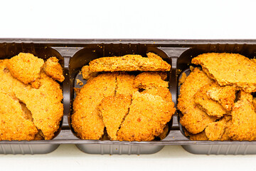 Broken butter biscuits in a plastic box