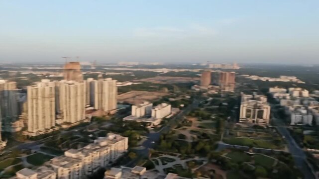 Aerial View of Greater Noida Skyline - This video captures a panoramic aerial view of Greater Noida's skyline, showcasing a mix of modern high-rise buildings and ongoing construction projects.