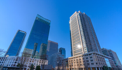Fototapeta premium Modern office towers and blue sky in Tokyo, Japan