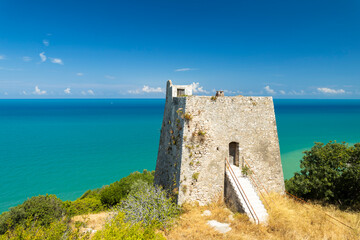 Medieval watchtower overlooking the turquoise Adriatic Sea in Peschici, Italy