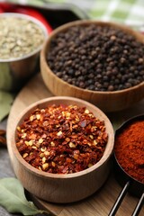 Different aromatic spices on wooden table, closeup