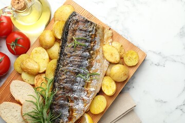 Homemade seafood dish. Tasty roasted mackerel with spices and vegetables on white marble table, flat lay. Space for text