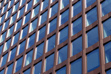 Modern office building facade with brown grid and glass windows