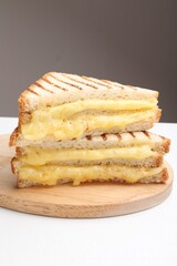 Tasty sandwiches with melted cheese on white table, closeup