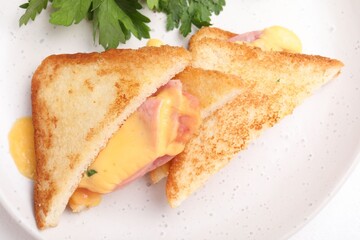 Delicious sandwiches with melted cheese and ham on white table, closeup