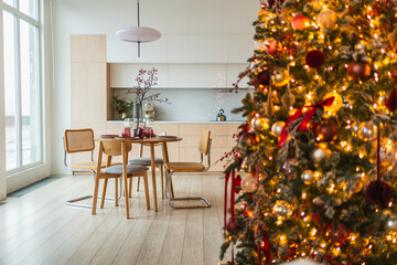 Classical Christmas decorated interior kitchen. Modern classic style interior design apartment dining room and Christmas tree with red golden ornament decorations. Christmas eve at home