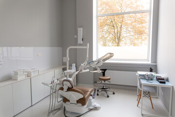 A bright modern dental office with a new patient chair and advanced equipment
