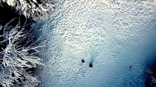 A tranquil drone video flying high above the snow covered landscape