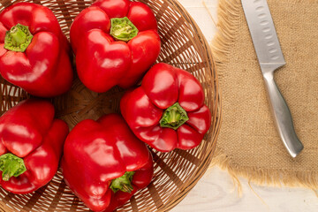 Red bell peppers on a wooden table, close-up, top view.	